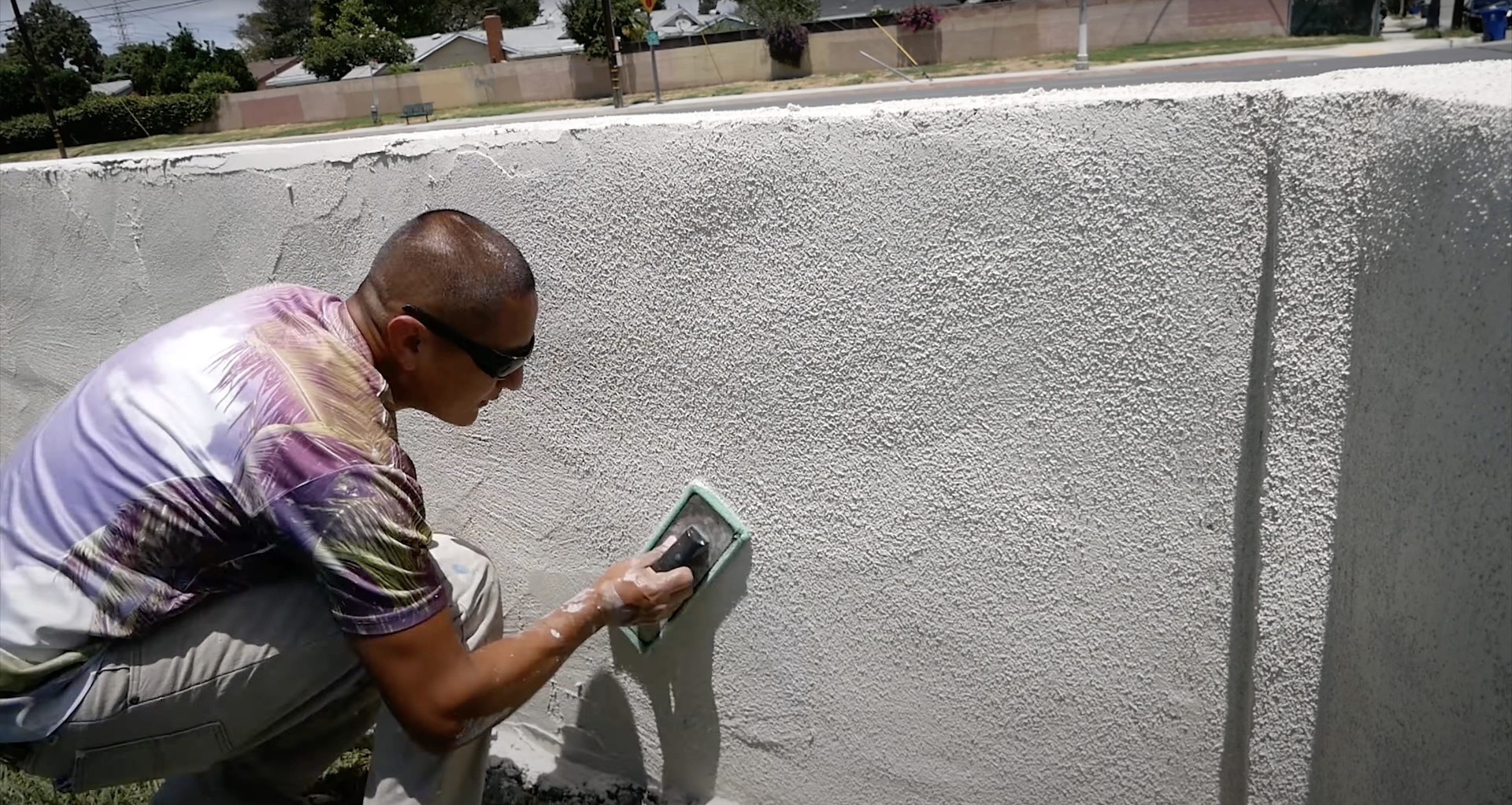 Professional Concrete Finishing - Expert applying specialized textured finish techniques Professional concrete contractor applying specialized textured finish to concrete surface using expert techniques