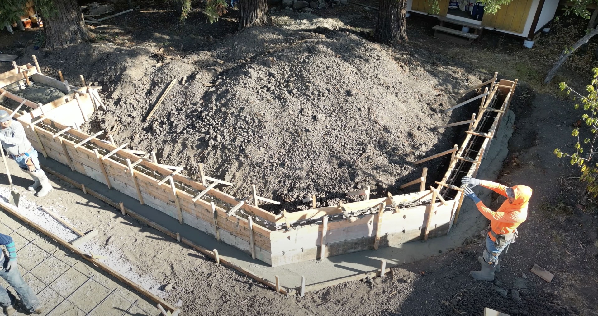 Foundation Construction - Site preparation and forming for commercial concrete foundation Concrete foundation construction site with wooden forms and excavation preparation for commercial project